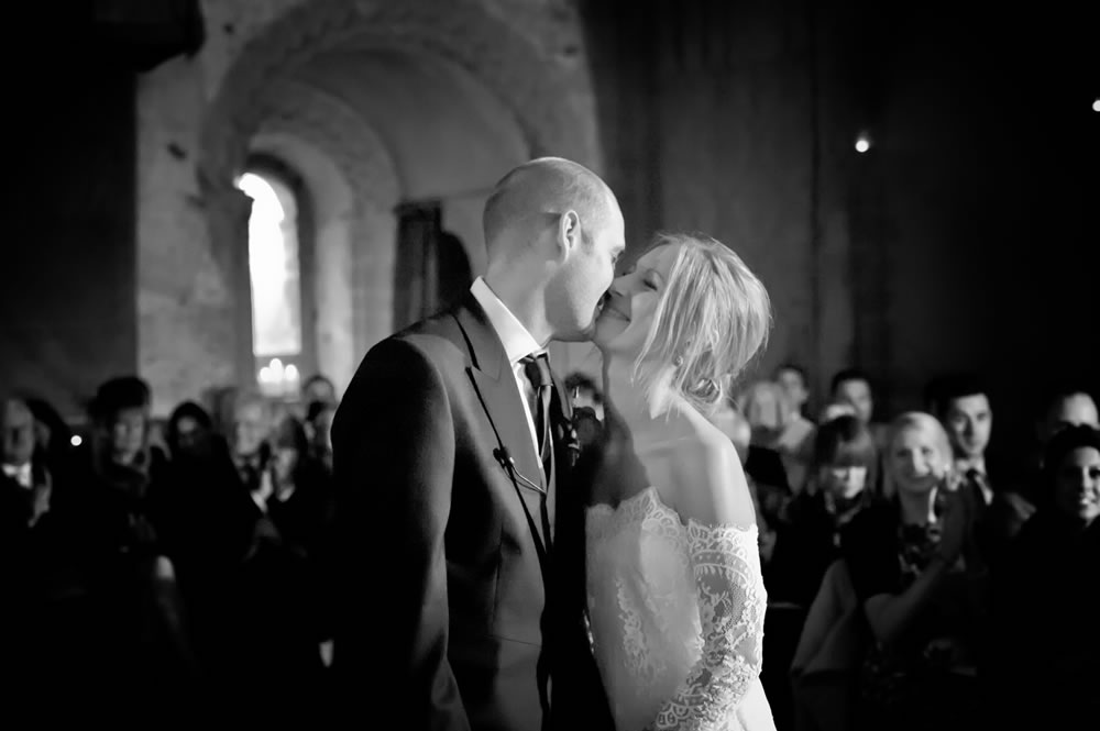 Bride and groom sharing their first kiss