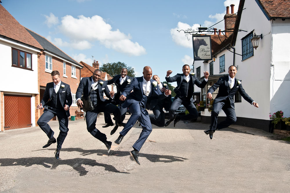 Jumping male bridal party