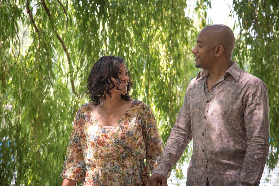 Couple walking under willow tree