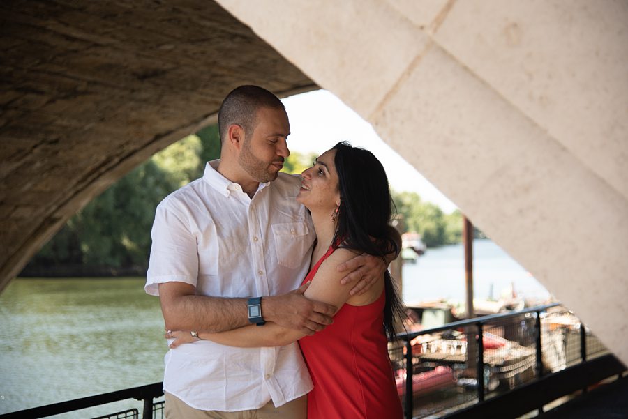 Couple hugging under bridge