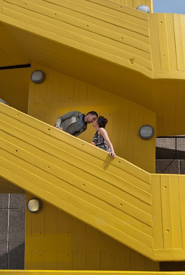 Couple kissing on yellow staircase