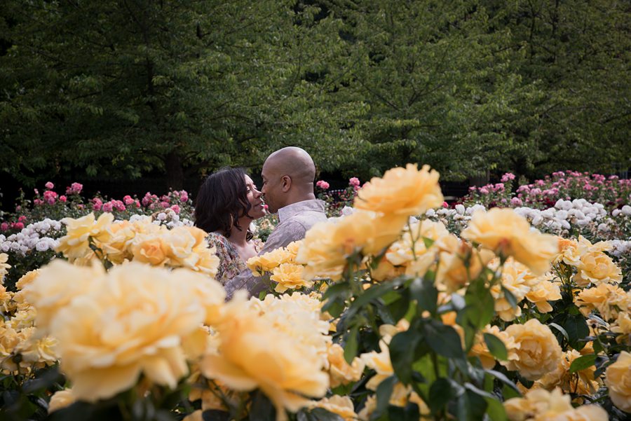 Couple hugging surrounded by flowers