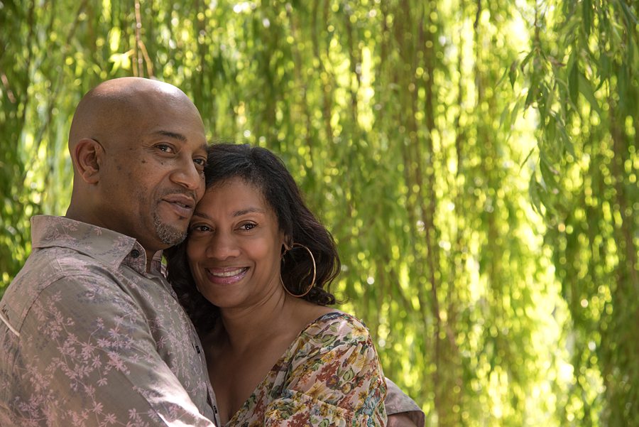 Couple hugging under willow tree