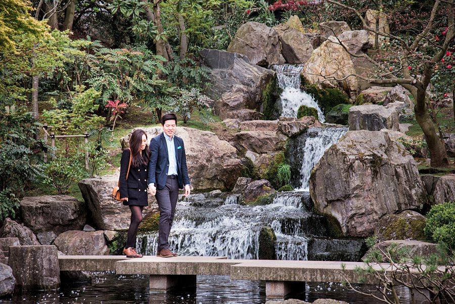 Couple walking across bridge in Japanese Garden