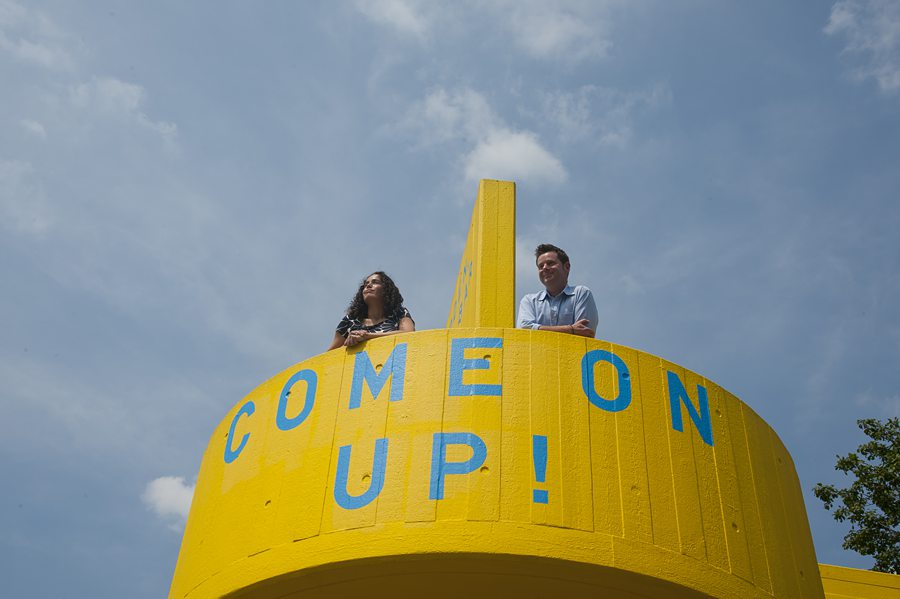 Couple looking out while on yellow staircase