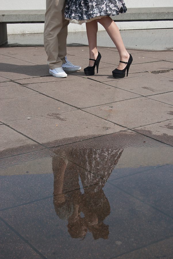 Reflection of couple kissing in a puddle