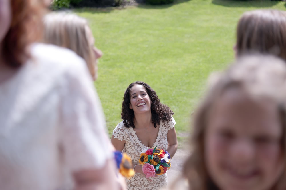 Bride getting ready to enter ceremony room holding flowers