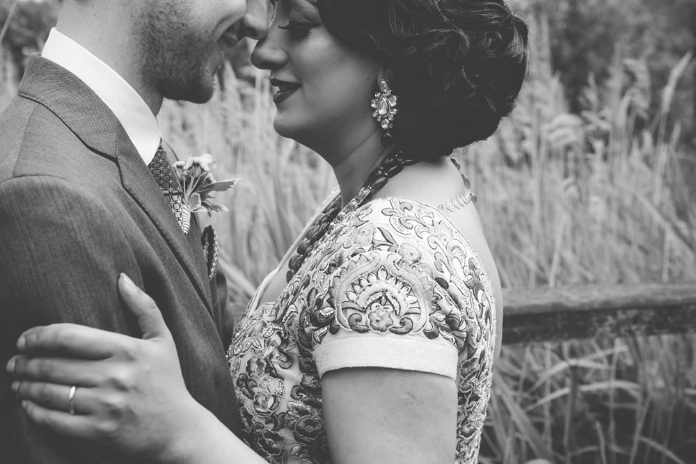 Asian bride and husband hugging