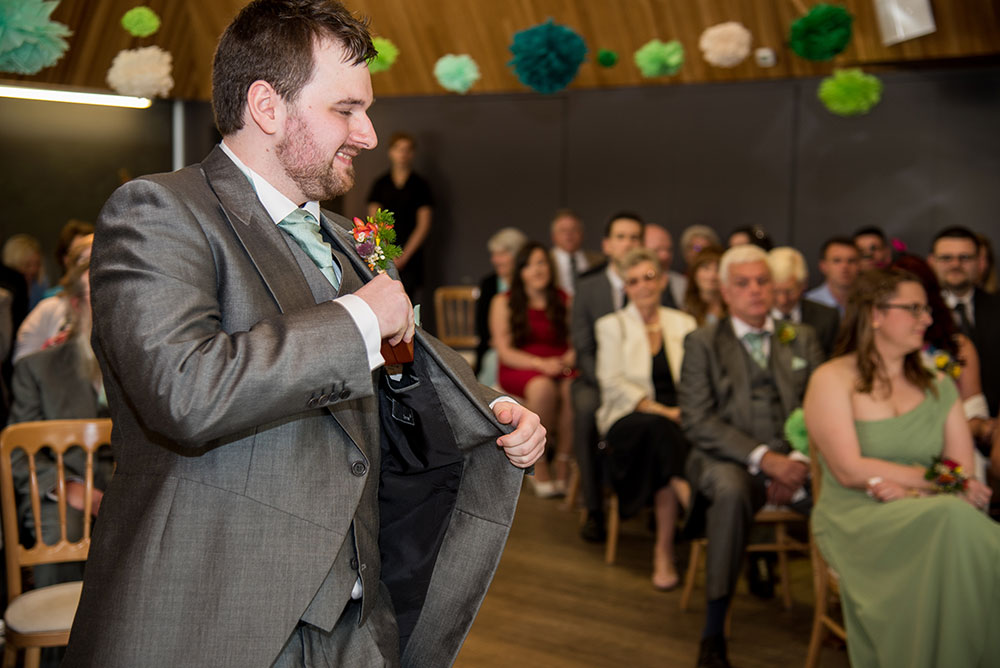 Best man getting the wedding rings out of his pocket