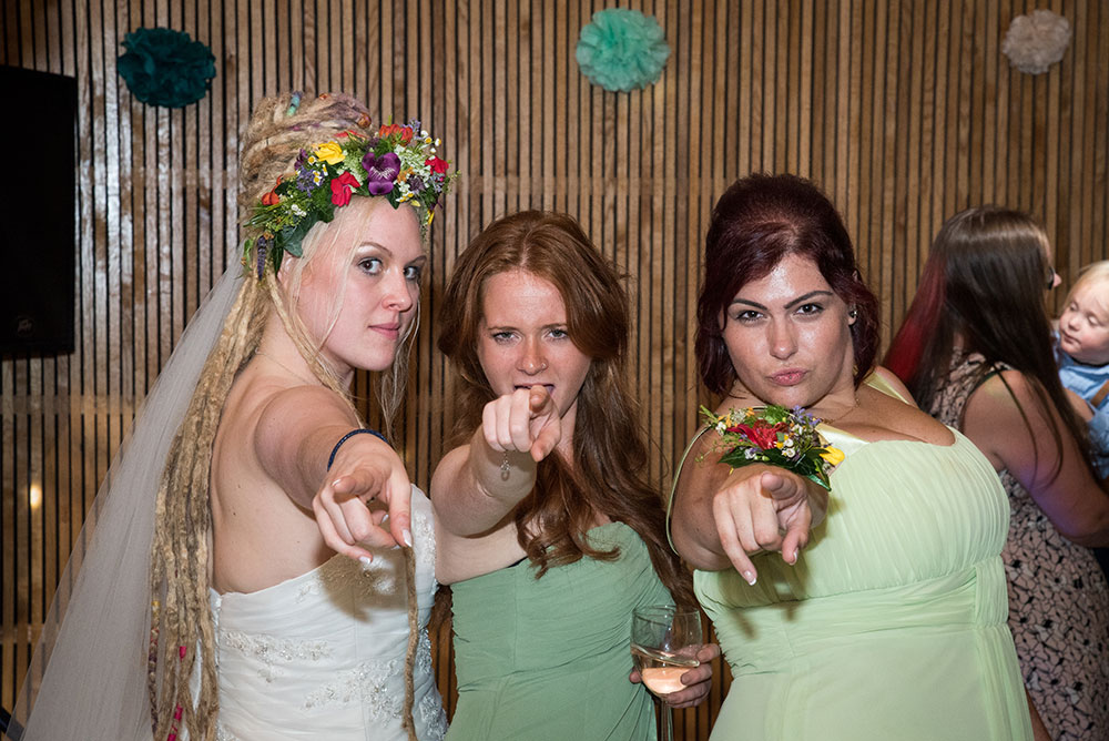 Bride with bridesmaids pointing at the camera