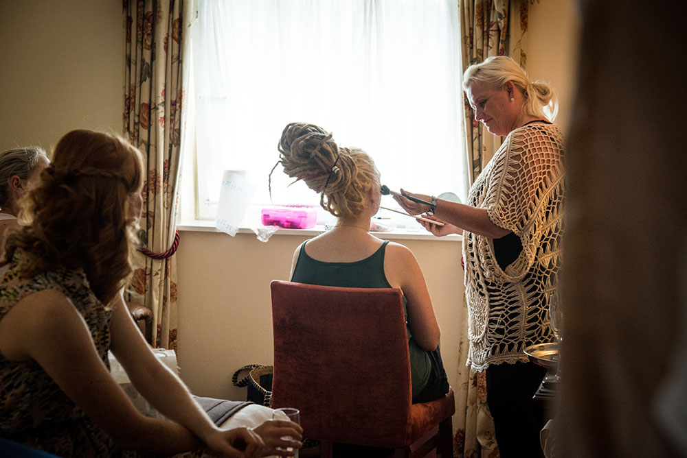 Back of bride while her make up is being done