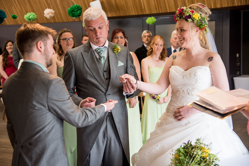 Father putting couples hands together