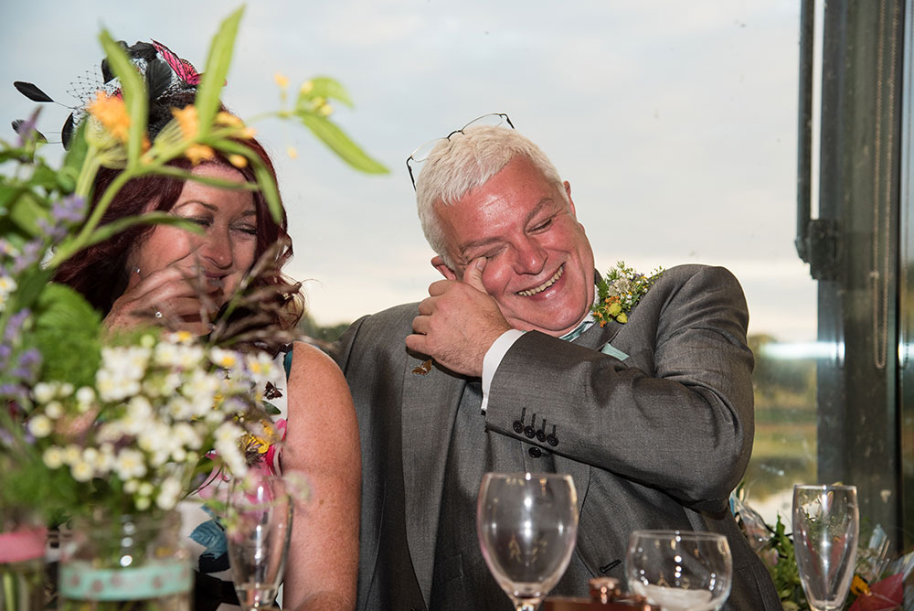 Father of the bride laughing during the speeches