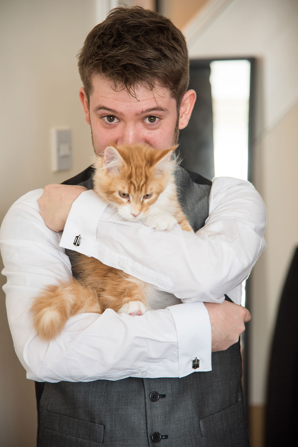Groom holding cat