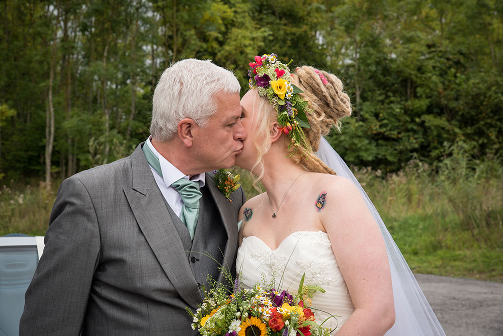 Bride kissing father before ceremony