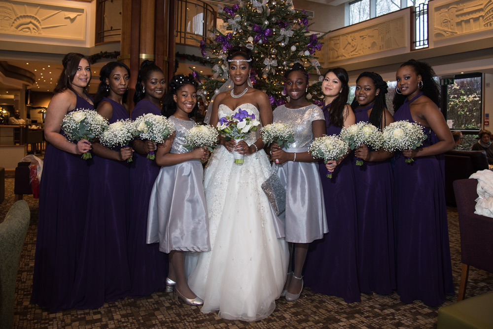 Bride with bridesmaid in front of hotel Christmas tree