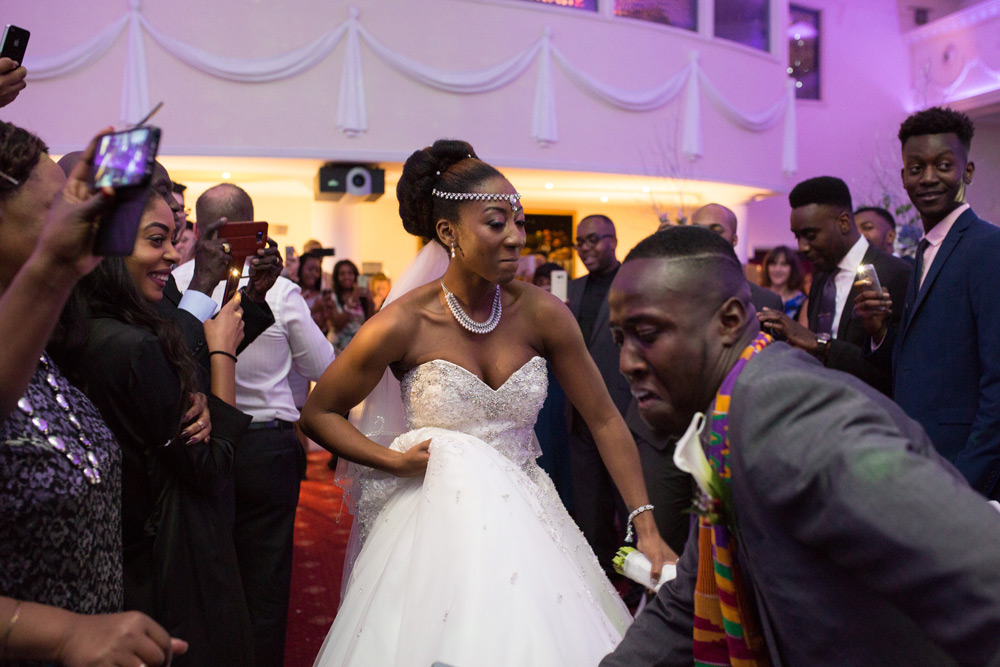 Bride and groom dancing into the reception room