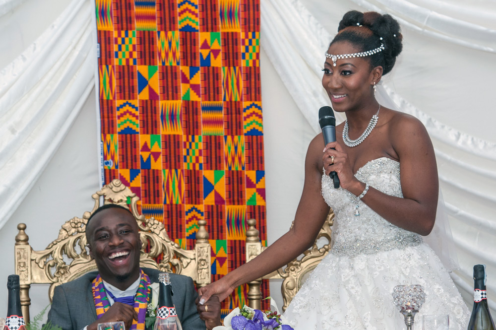 Groom laughing during bride&rsquo;s speech