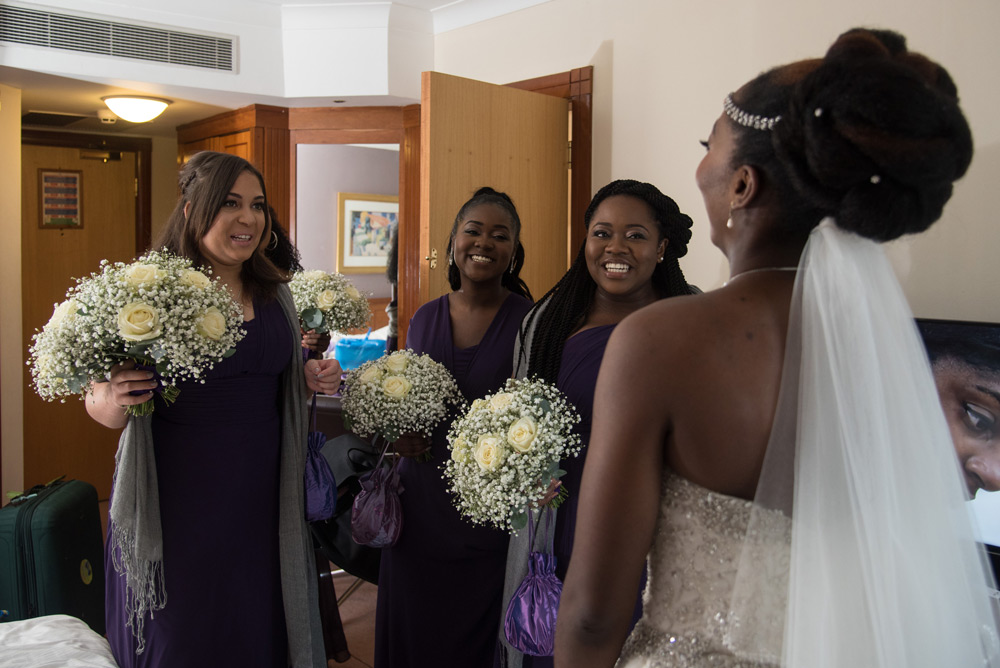 Bridesmaids&rsquo; reactions to bride in her dress