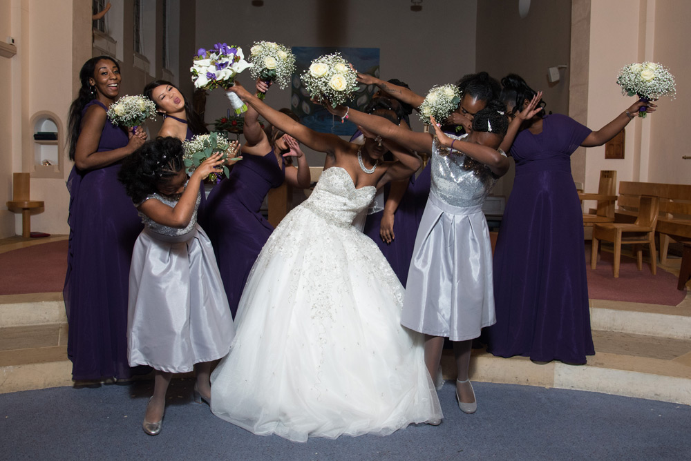 Bride and bridesmaids dabbing during their portrait