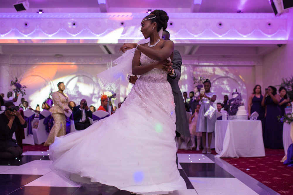 Groom twirling bride during first dance