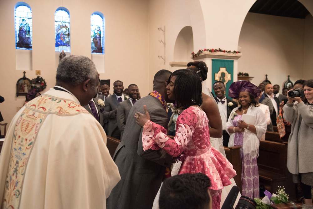 Groom hugs bride&rsquo;s mother at altar