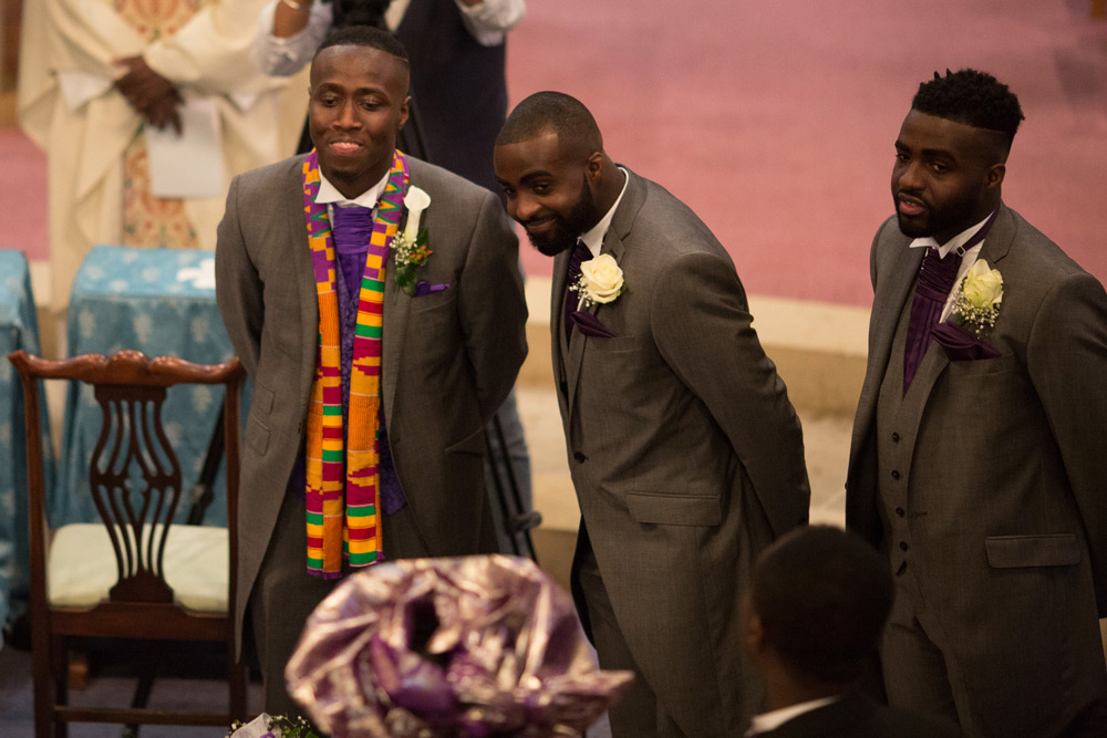 Groom with best men at the altar
