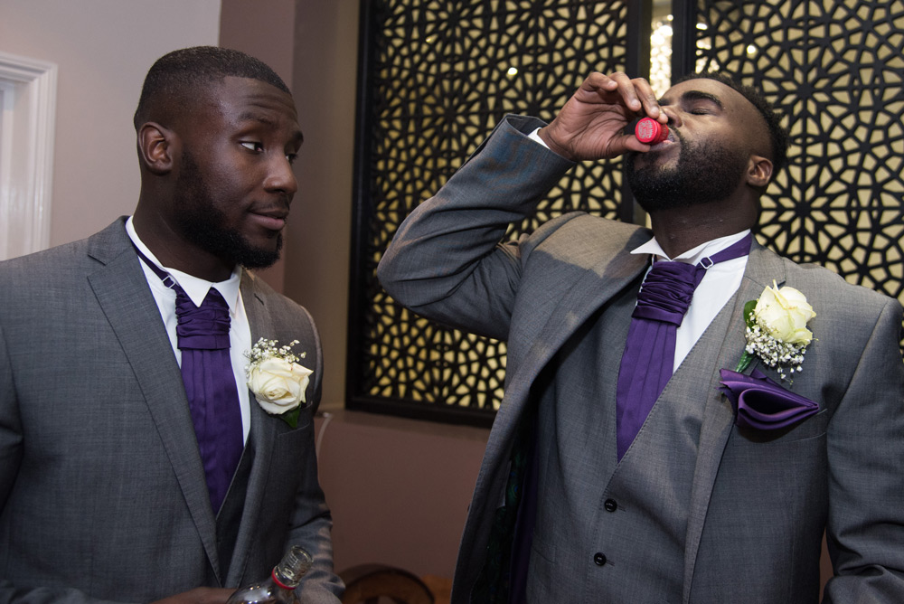 Groomsman having vodka shot