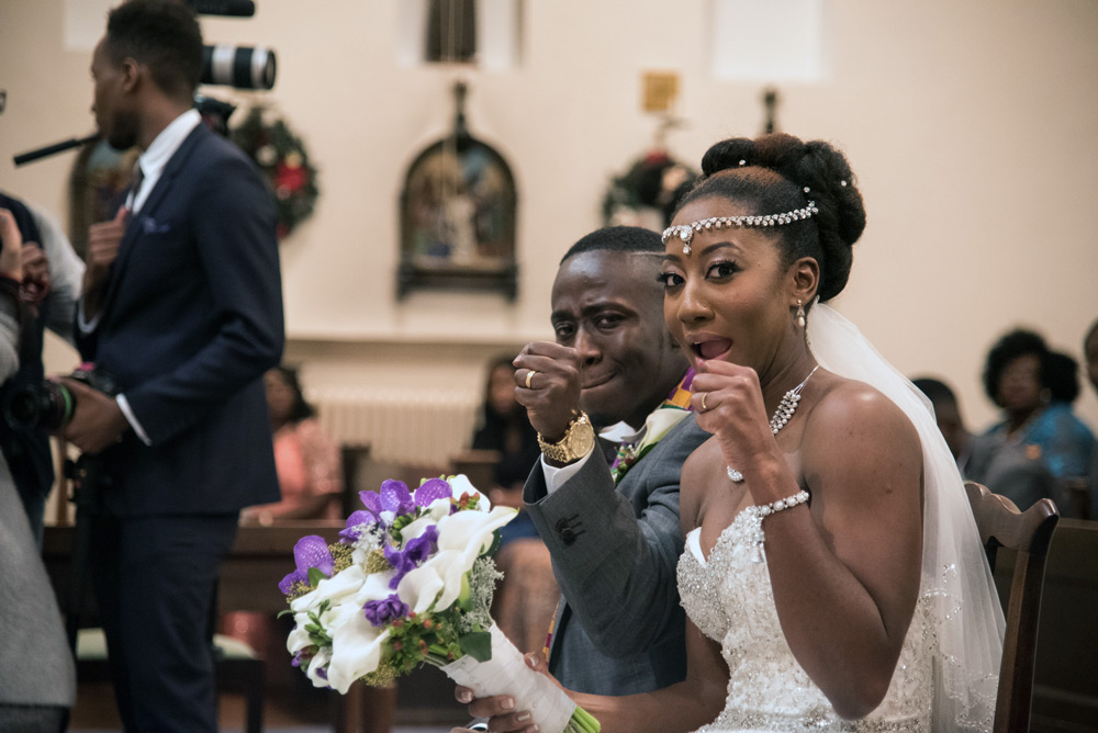 Bride and groom showing their rings to the camera