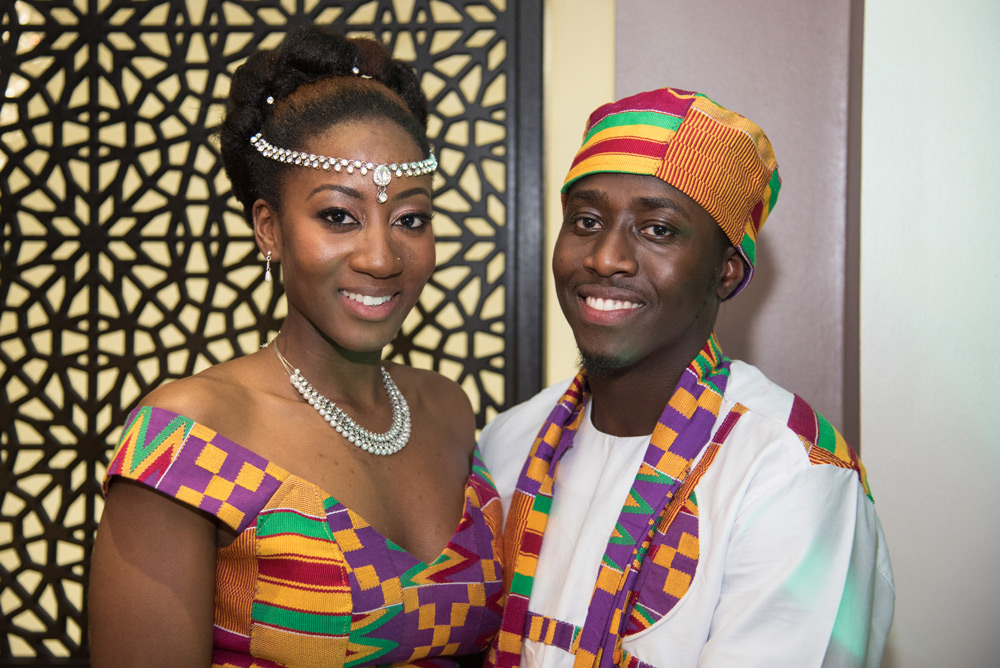 Bride and groom in kente cloth outfits
