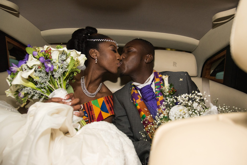 Couple kissing in back of car