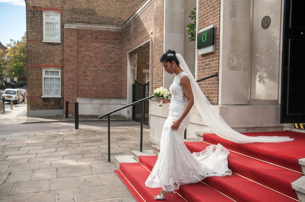 Bride walking down stairs of hotel
