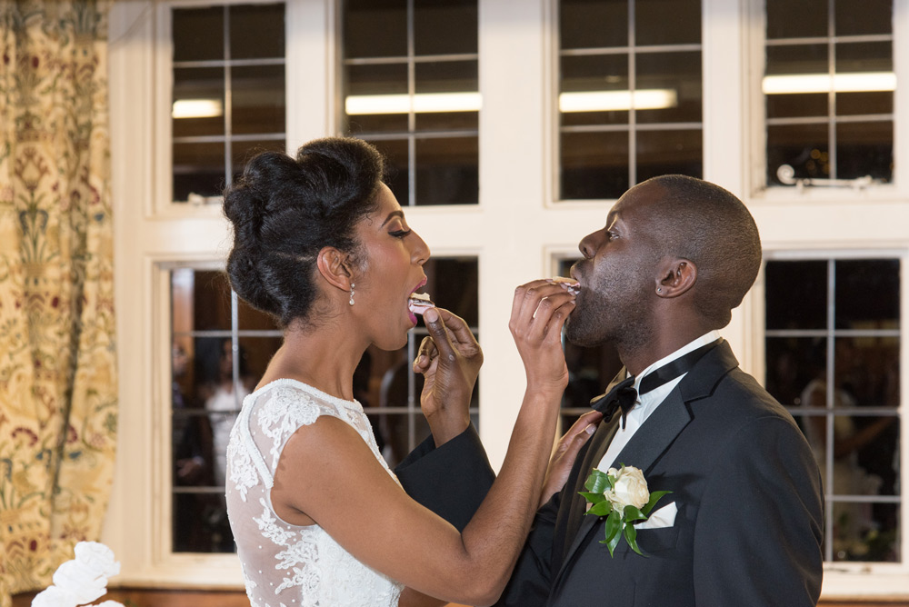 Couple feeding each other wedding cake