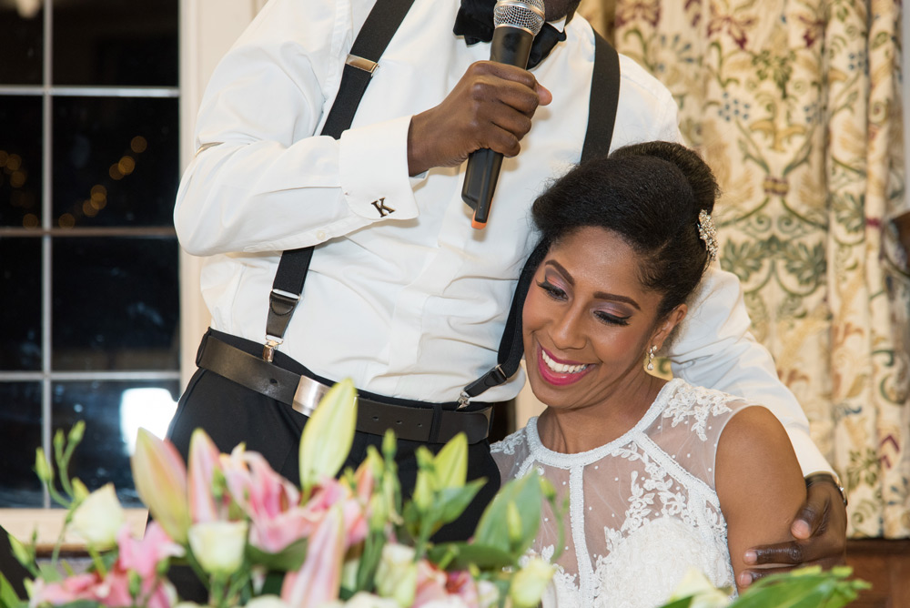 Groom hugging bride during his s peech