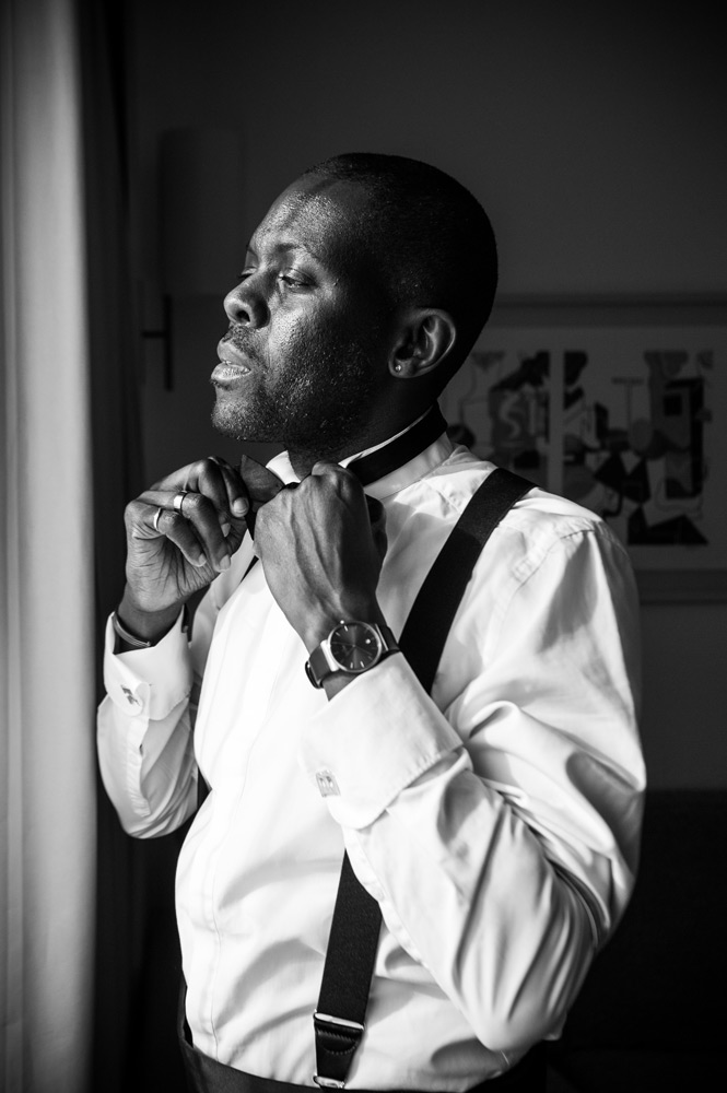 groom fixing his tie