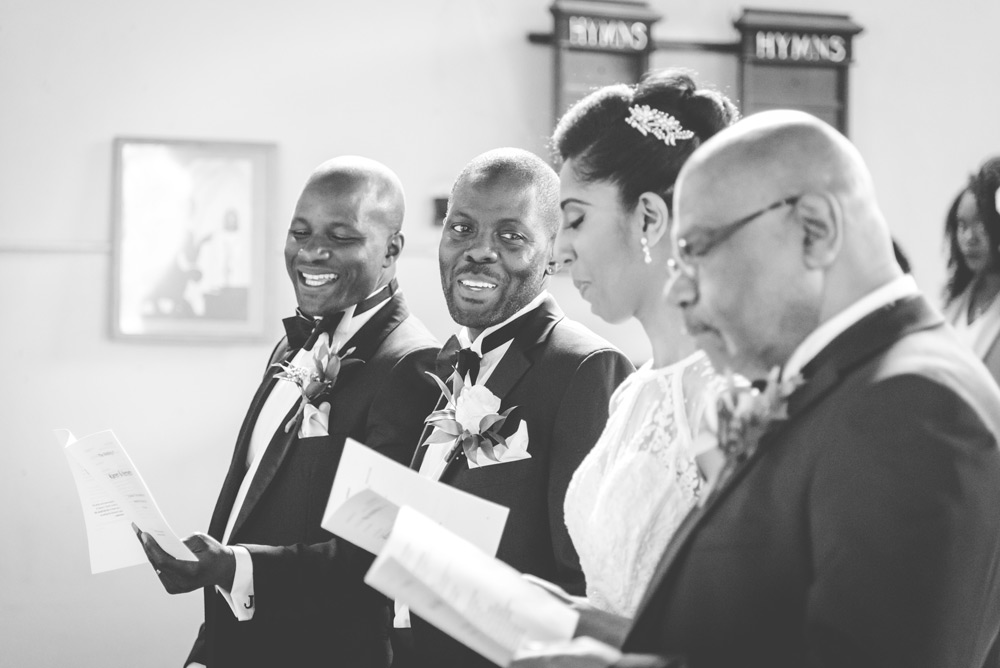 Groom looking at bride during service