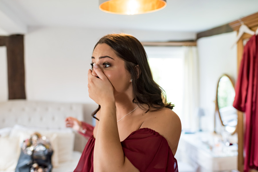 Bridesmaid shocked expression seeing bride in dress