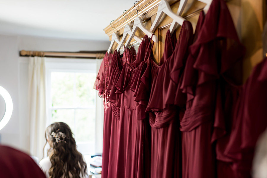 Bridesmaids dresses in the foreground with bride sitting in the background