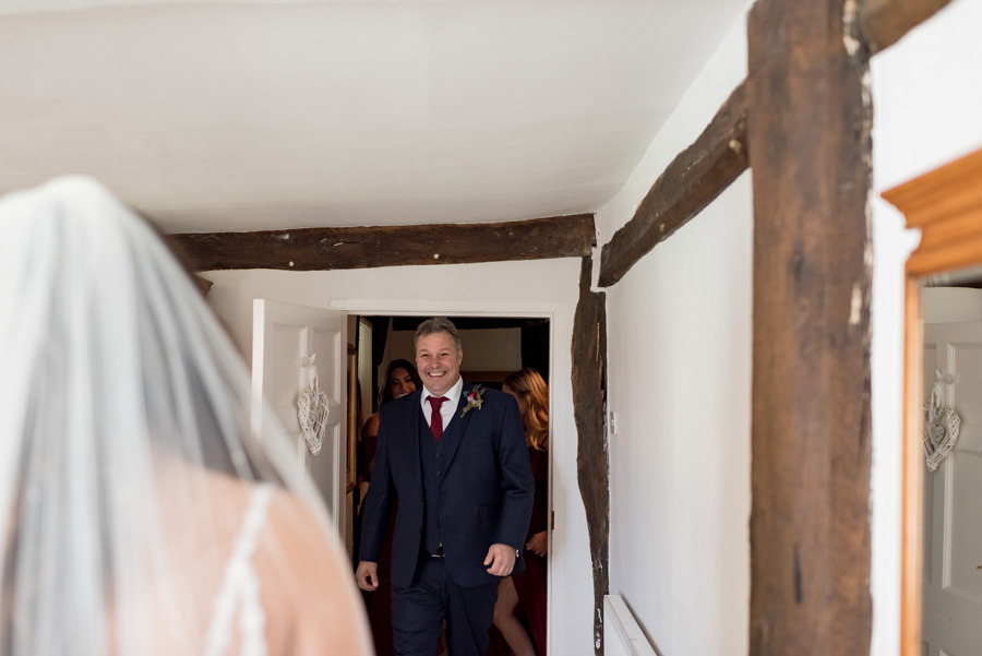 Father of bride seeing her in her dress for the first time