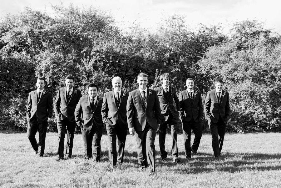 Groom with groomsmen walking