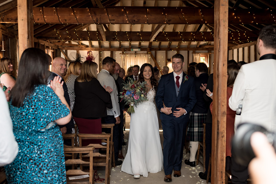 Couple now married leaving the ceremony