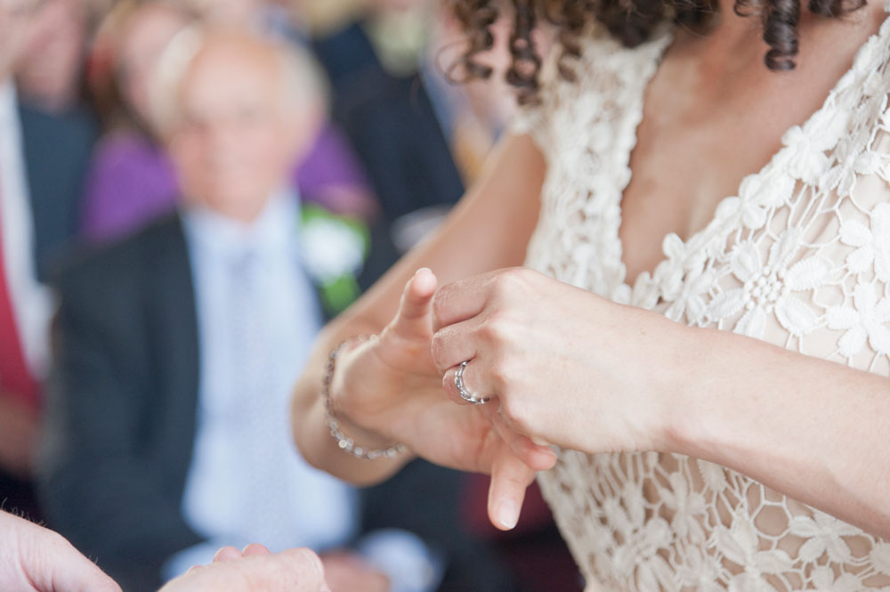 Bride trying to get her wedding ring on