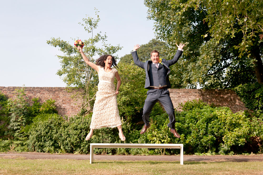 Couple jumping off bench