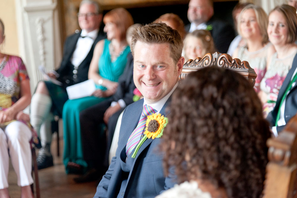 Groom looking at bride during service