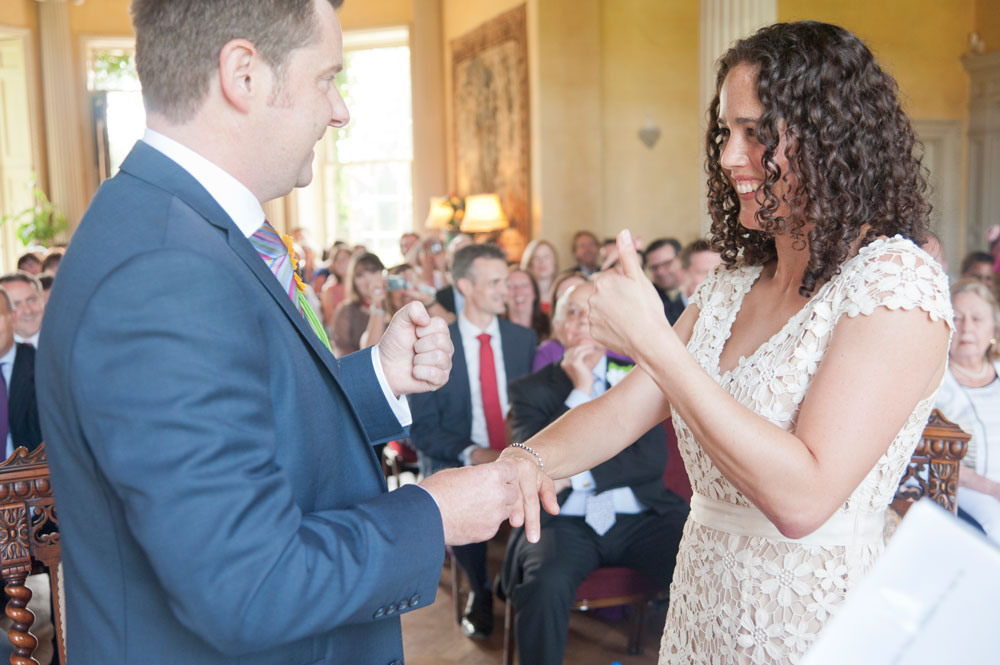 Bride giving groom thumbs up now her ring is on