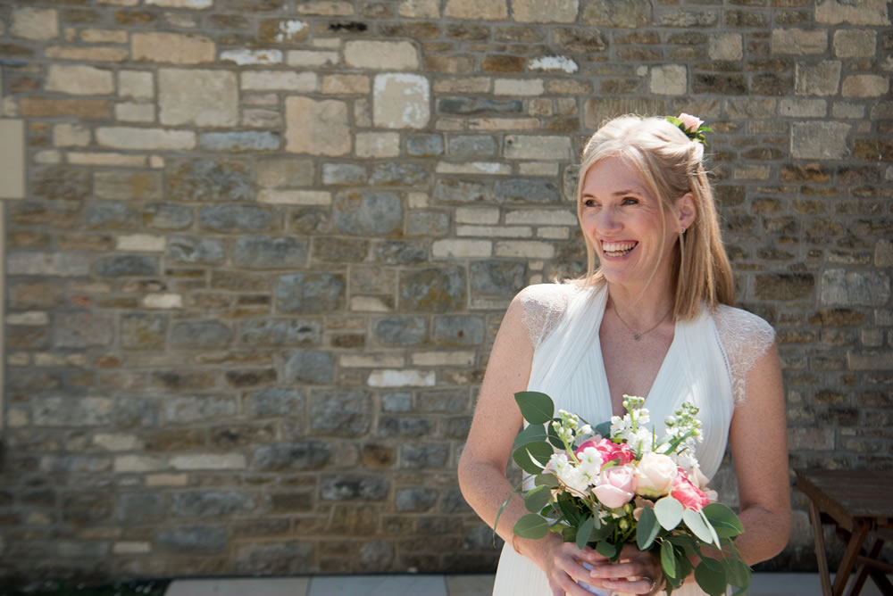 Bride smiling holding her wedding bouquet
