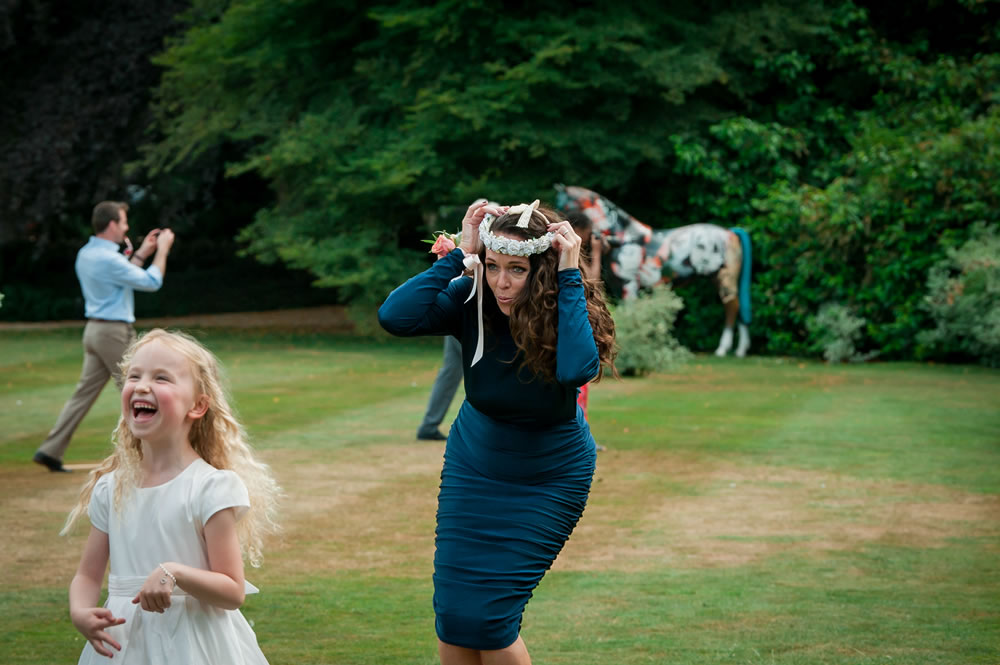 Bridesmaid playing with flowergirl