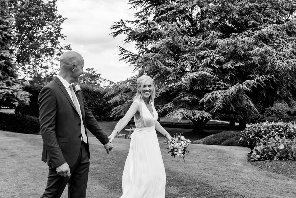 B&W of couple walking and laughing