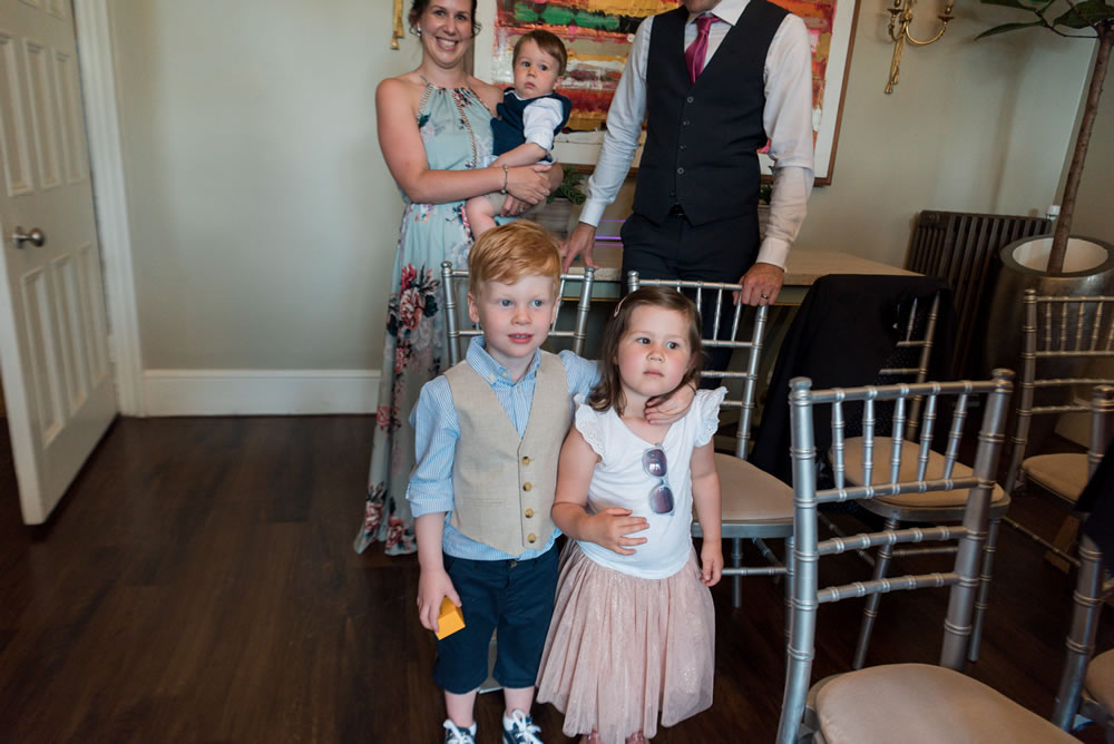 Page boy with arm around friend