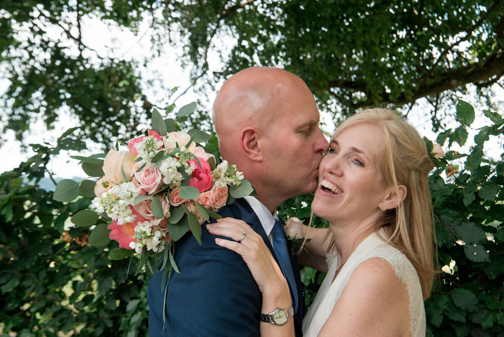 Bride and groom hugging and laughing